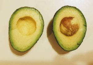 open faced avocado, one with seed