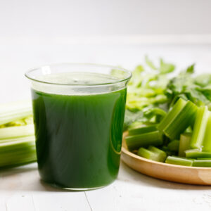 celery juice with celery in the background