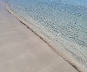 Clear water and white sand at Brandinchi Beach