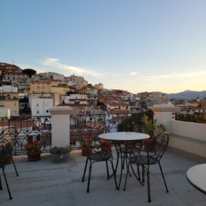 Table and chairs on a terrace at the hotel with views of the mountains