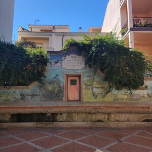 an aqueduct in the city with a mural 