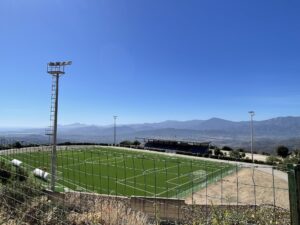 Soccer field surrounded by mountains 