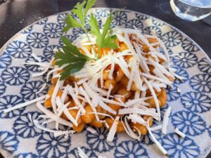 plate of gnocchi with tomato sauce and cheese on top